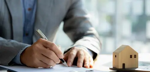 Mężczyzna podpisuje wniosek o wykreślenie hipoteki przymusowej
