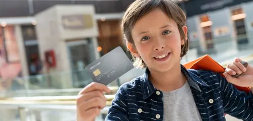 Chłopiec z kartą płatniczą na zakupach