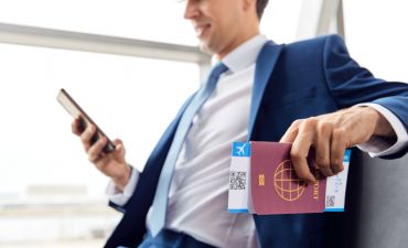 mężczyzna z polisą przeglądający wiadomości na telefonie