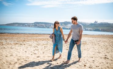 Para idąca za rękę po plaży na Malcie