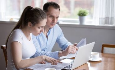 para młodych ludzi siedzi przed laptopem i analizuje oferty w internecie