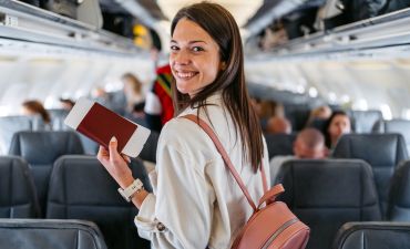kobieta na pokładzie samolotu z dokumentami w ręku