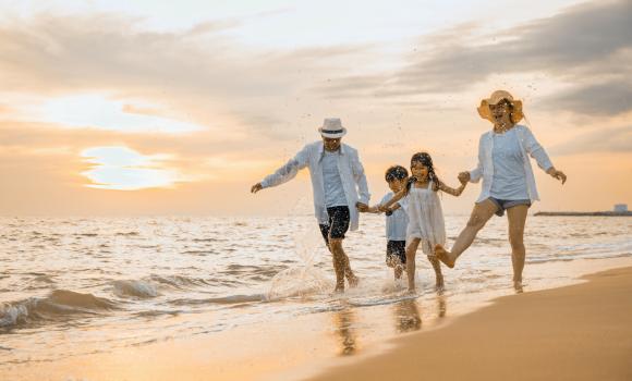 Rodzina na plaży o zachodzie słońca